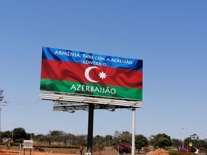 Panel covered with writing that says "Armenia, stop aggression against Azerbaijan!" set on highway in Brazil 