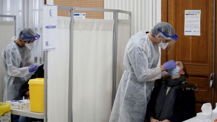 France orders curfew in nine cities to battle virus