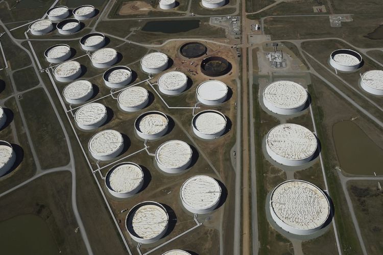 Oil inches lower on concerns over COVID-19 surge in India, Japan
