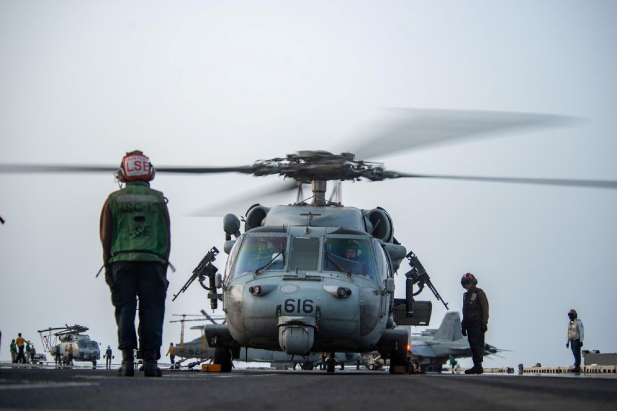 Sailors prepare an MH-60S Sea Hawk helicopter