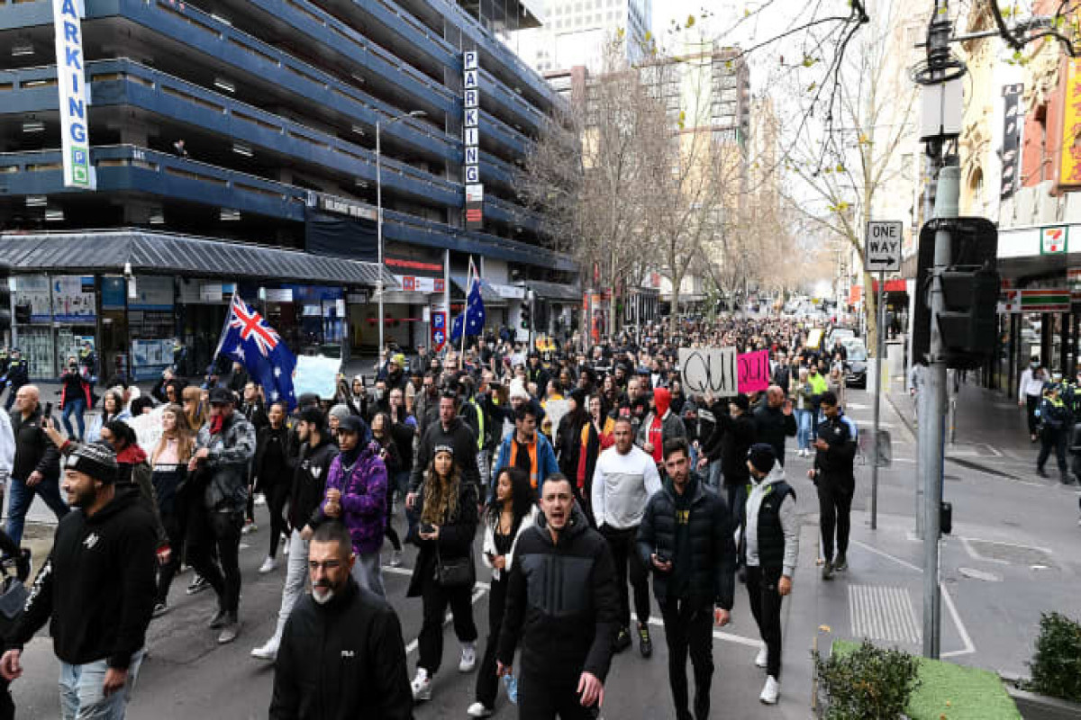 Police clash with protesters as Australia reports record Covid cases
