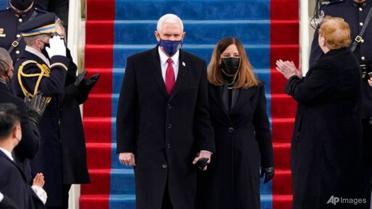 Trump's vice president Pence applauds successor at inauguration