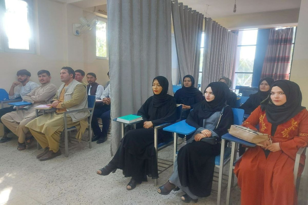 A curtain divides male, female students as Afghan universities reopen