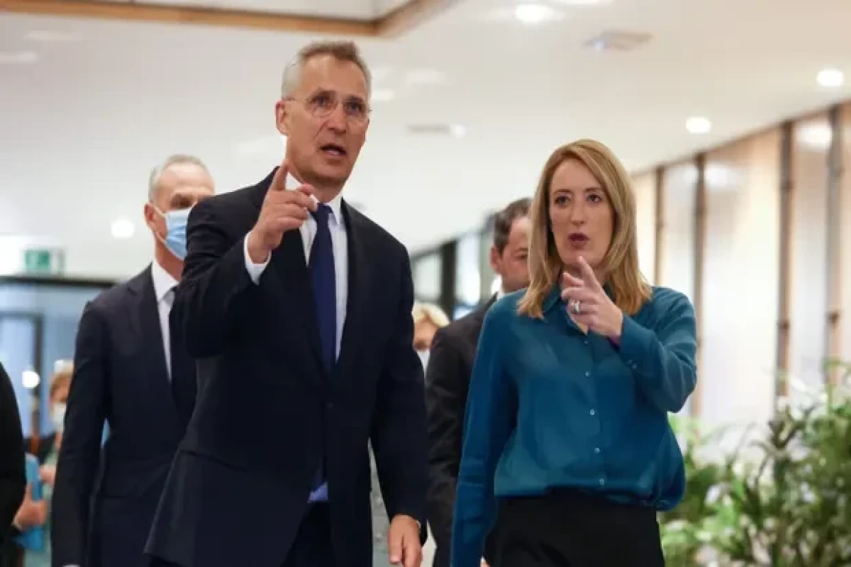 European parliament president Roberta Metsola (R) welcomes Nato secretary general Jens Stoltenberg at the European parliament in Brussels