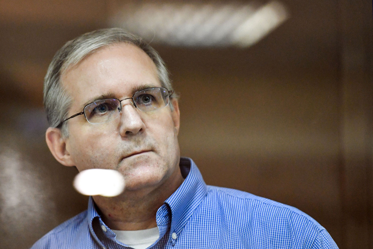 Paul Whelan stands inside a defendants' cage during a hearing at a court in Moscow