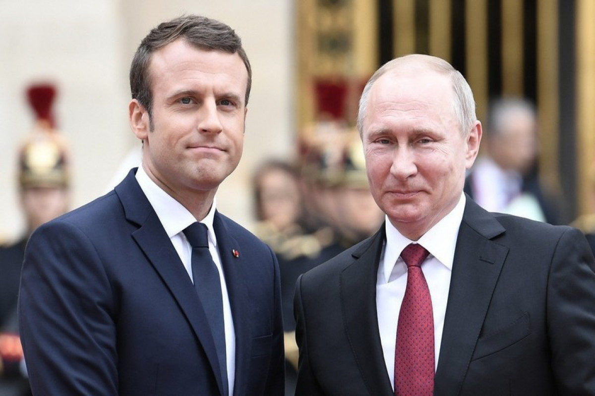 French President Emmanuel Macron , Russian President Vladimir Putin