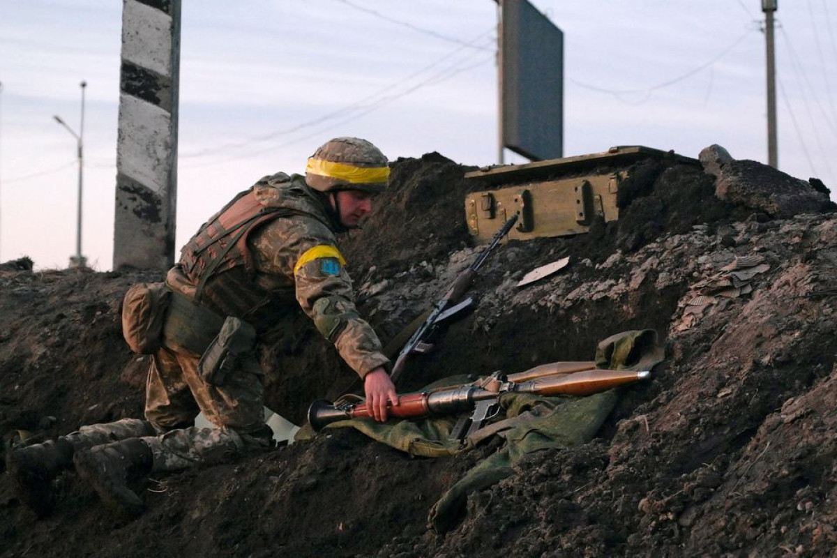 A Ukrainian serviceman holds a rocket-propelled grenade (RPG) launcher at fighting positions outside the city of Kharkiv, Ukraine February