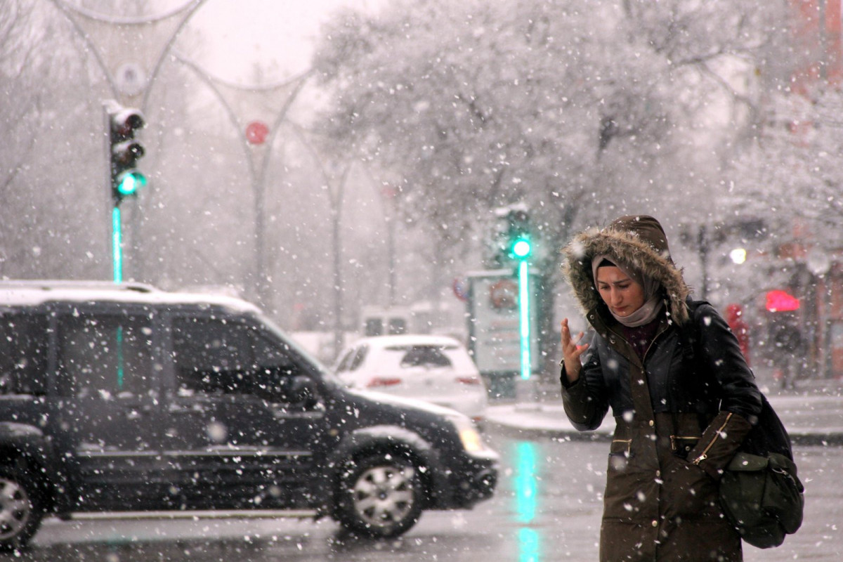 A woman walks amid snowfall in Erzincan, eastern Turkey, Jan. 3, 2022.