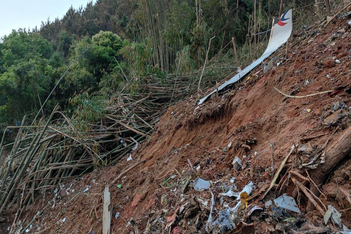 China plane crash: Rescuers search for survivors as families await news
