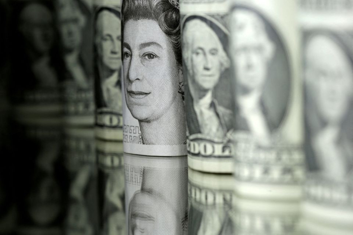Dollar gains, stocks slip as Fed officials talk tough on rates