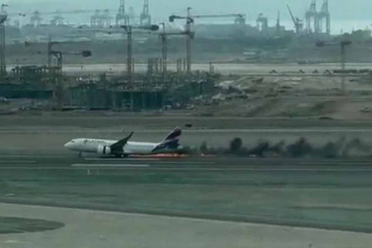 Passenger plane bursts into flames after 'colliding with truck' at airport-PHOTO 