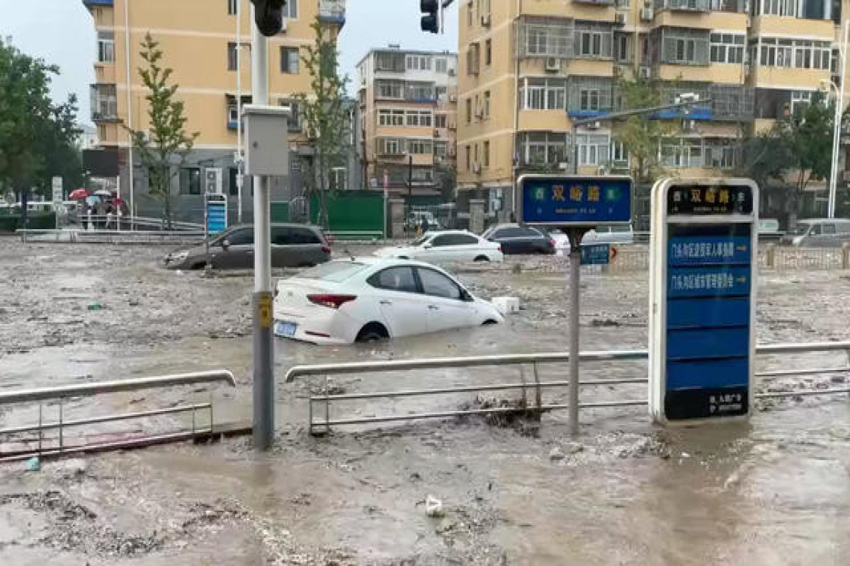 Heaviest rain in a decade kills 11 in Beijing as raging torrents wash away roads and cars