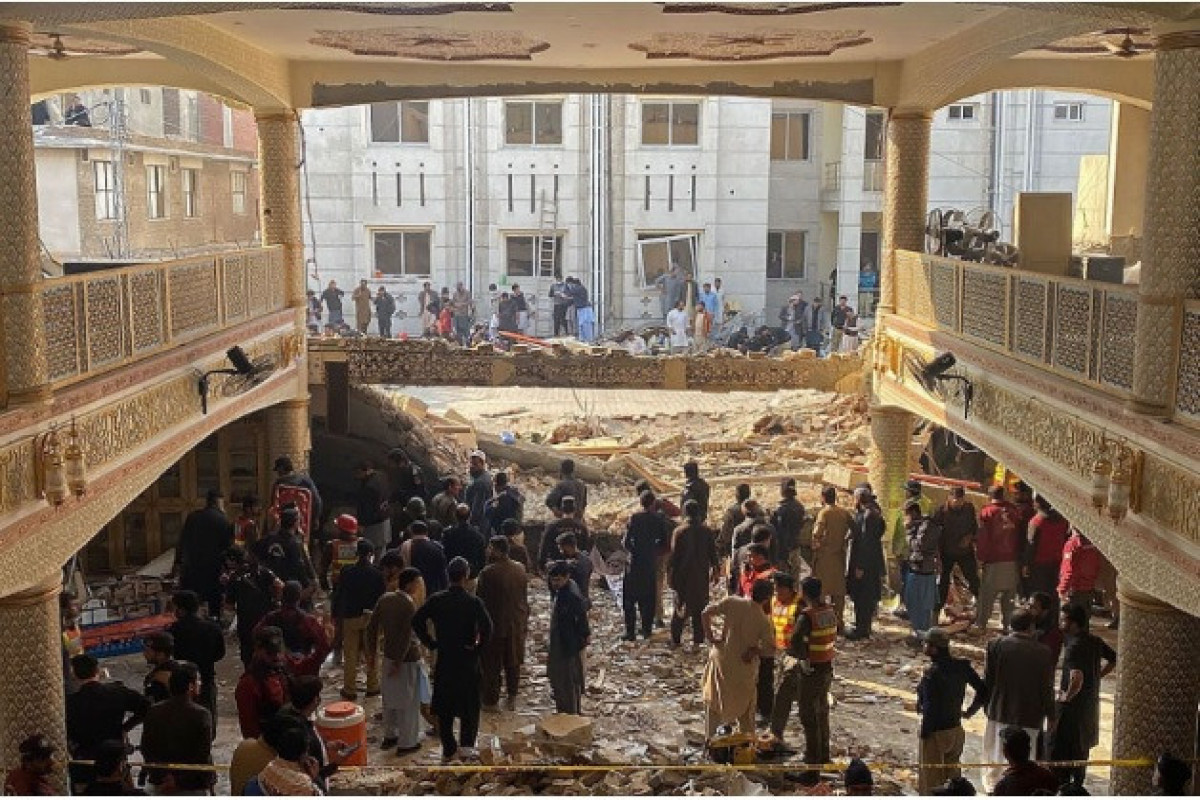 Death toll from blast in Pakistan mosque rises to at least 100