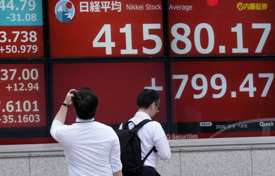 Japan's Nikkei index wins back more than half of losses after a historic collapse