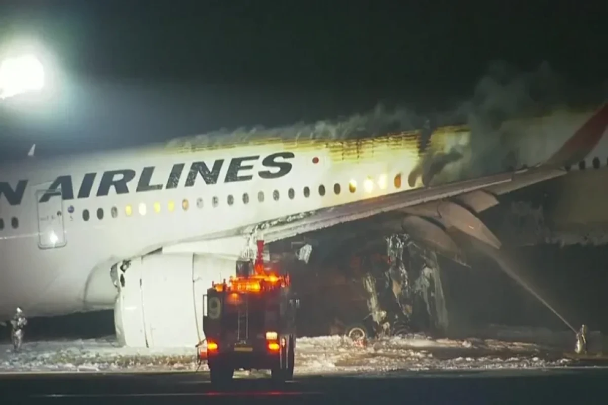 Japan Airlines plane in flames on runway at Tokyo's Haneda airport
