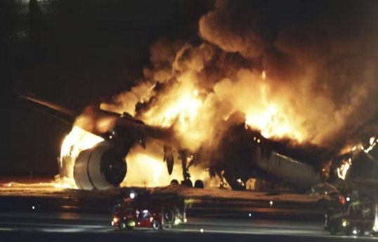 Planes collide in fiery crash on runway at Tokyo airport, 5 missing