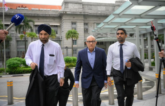 Singapore minister charged with corruption, resigns, in rare case