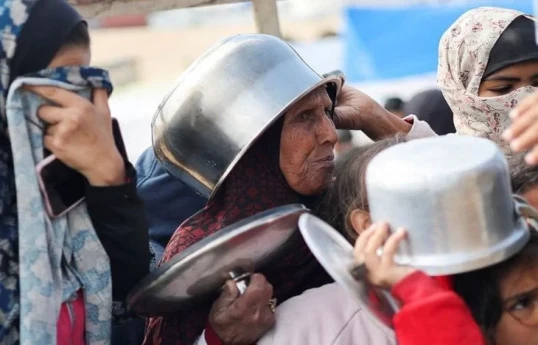 Dozens killed waiting for aid in Gaza, overall death toll passes 30,000