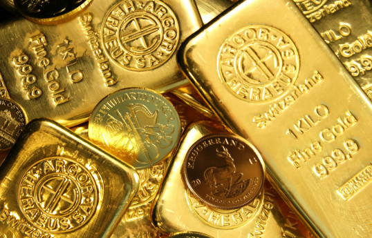 Gold eases off two-week peak as dollar ticks up