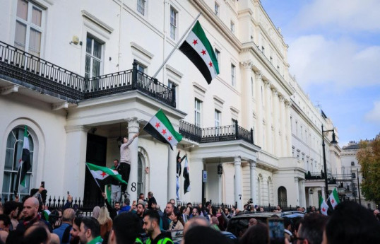 Syrian Foreign Minister raises national flag as embassy reopens in London
