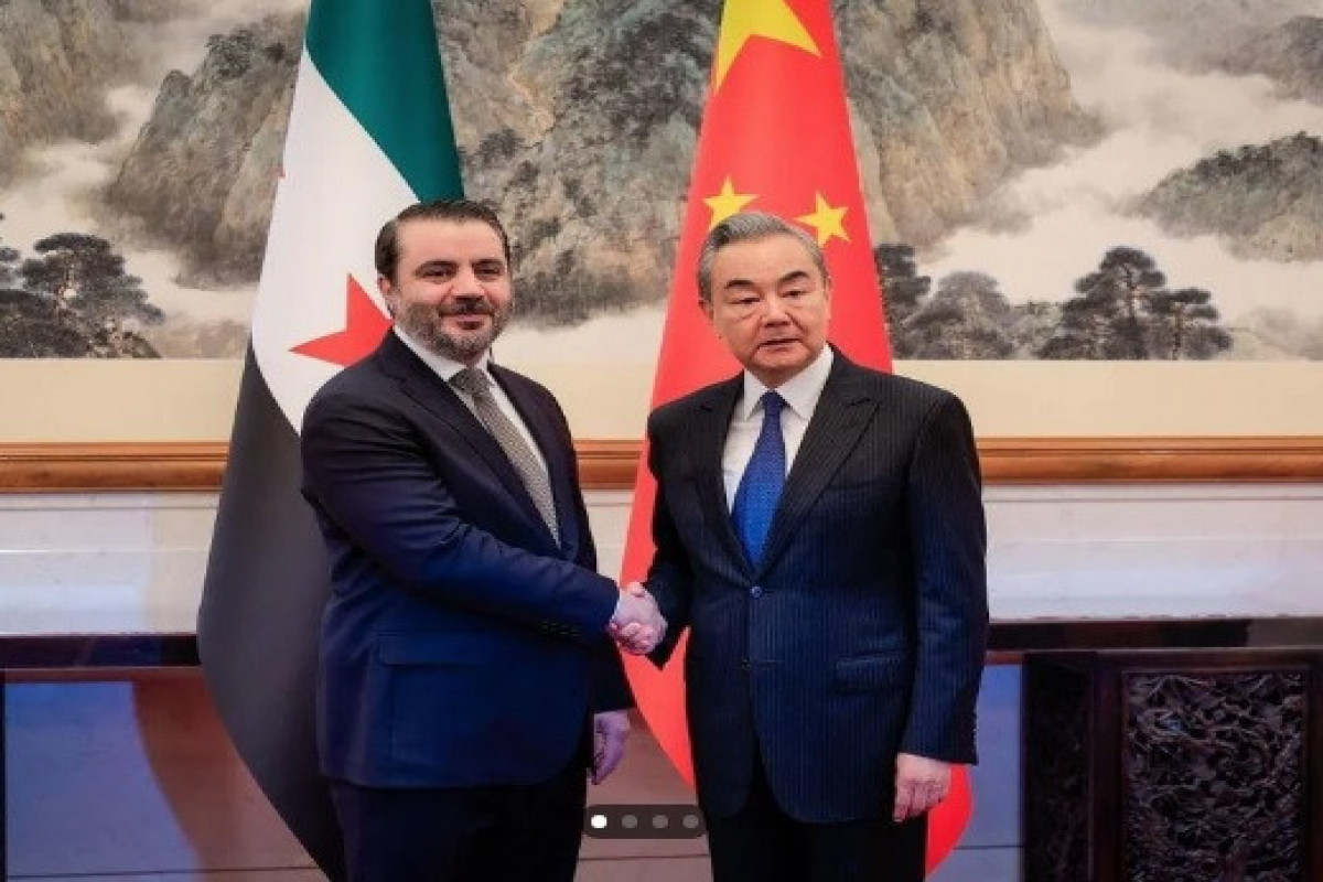 Syrian Minister of Foreign Affairs and Expatriates Asaad Hassan Al-Shaibani, Chinese Foreign Minister Wang Yi
