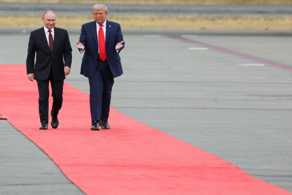 Russian President Vladimir Putin and U.S. President Donald Trump walk on the tarmac after they arrived to attend a meeting at Joint Base Elmendorf-Richardson in Anchorage, Alaska, U.S., August 15, 2025.