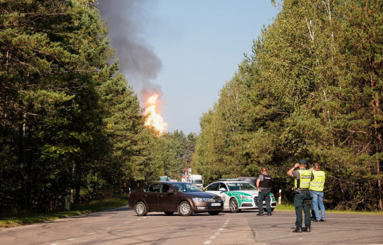 Explosions heard in Lithuania's capital after rail cars loaded with liquefied gas catch fire