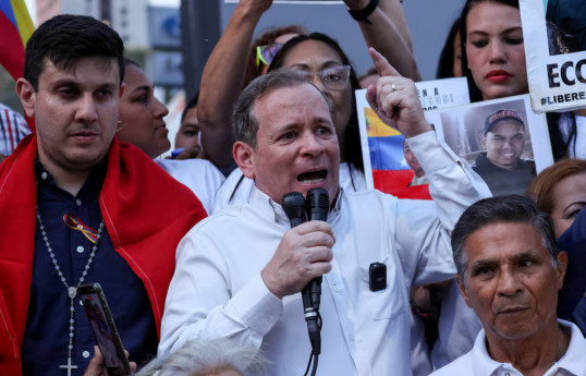 Venezuelan opposition politicians Jesus Armas and Juan Pablo Guanipa greet relatives of the political prisoners outside the Helicoide detention center after they were both released from detention