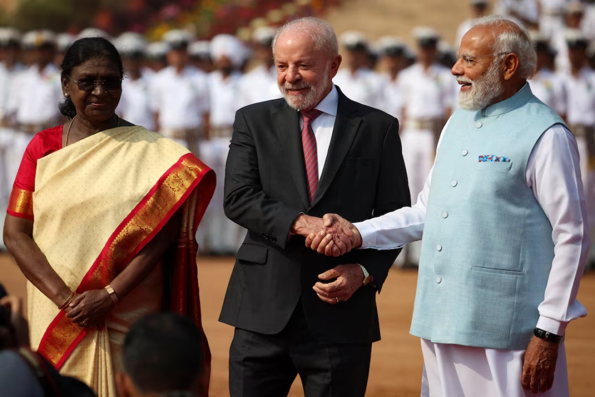 Indian Prime Minister Narendra Modi shakes hands with Brazilian President Luiz Inacio Lula da Silva, next to India