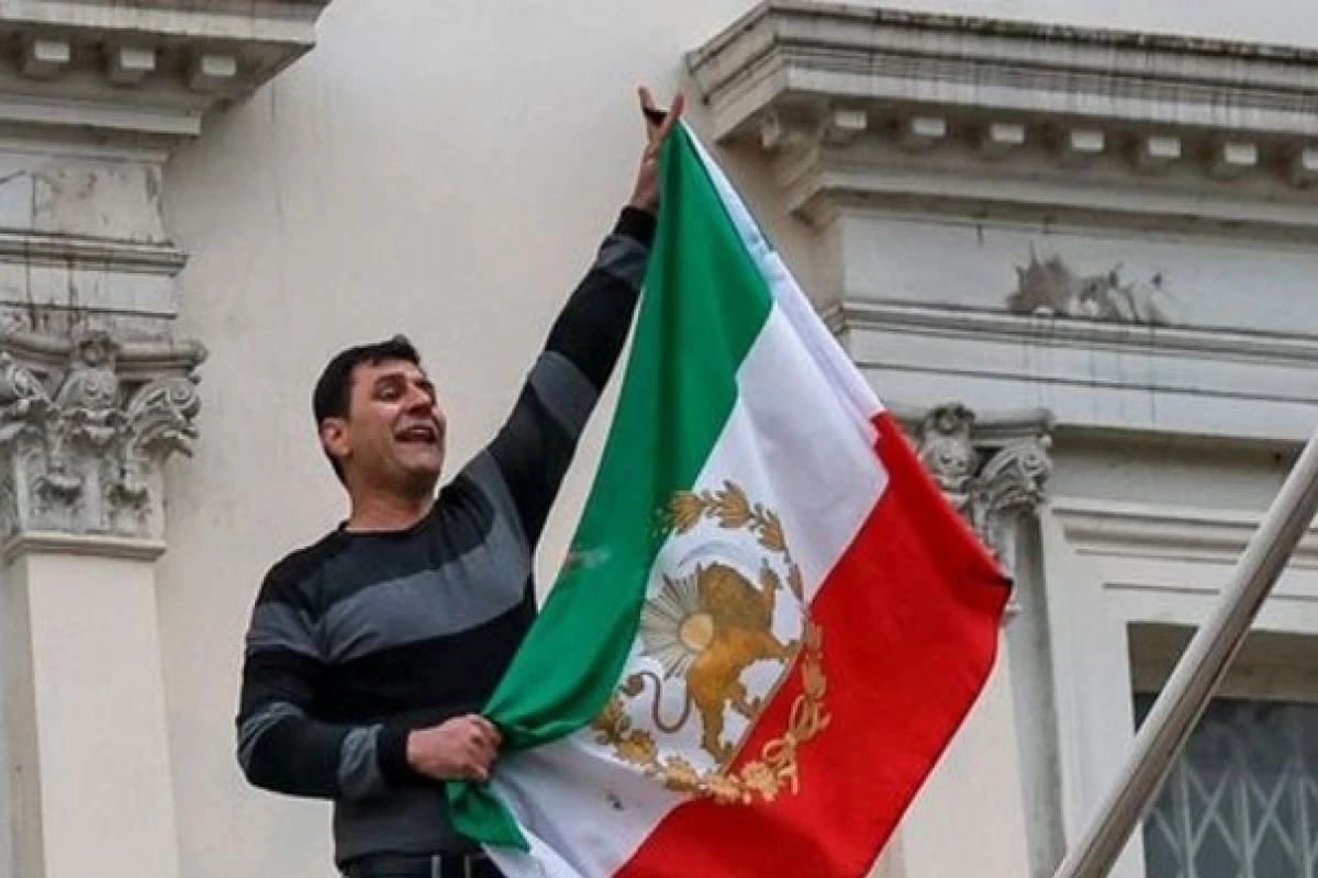 Protester arrested after taking down flag at Iranian Embassy in London