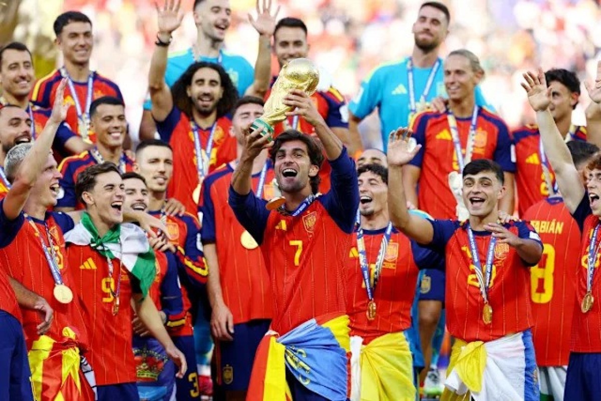 Spain receive their winner medals ahead of raising the World Cup trophy