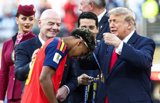 Spain receive their winner medals ahead of raising the World Cup trophy