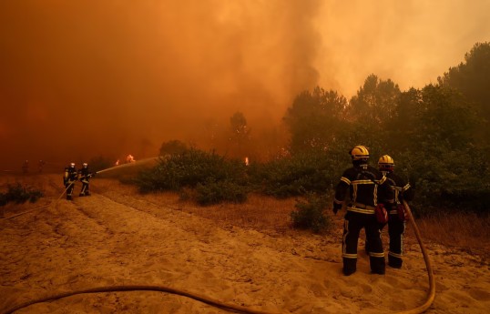 Tens of thousands flee fires in France, blazes merge outside Madrid