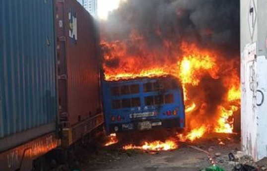 A cargo train hits a public bus at a Bangkok rail crossing, killing at least 8