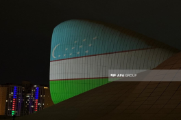 Heydar Aliyev Center building is illuminated in colors of Uzbek flag