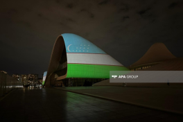 Heydar Aliyev Center building is illuminated in colors of Uzbek flag