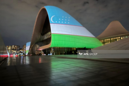 Heydar Aliyev Center building is illuminated in colors of Uzbek flag